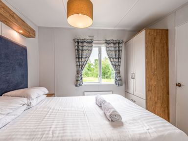 A bedroom with a bed and window at Caistor Spa in Louth