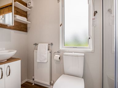 A bathroom with a toilet and wash basin at Caistor Spa, Louth