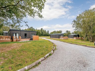 Cabins near a gravel road in a natural setting at Horncastle Plus in Louth