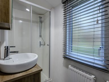 A bathroom with a shower and sink at Alford Spa in Louth
