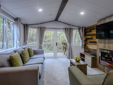 A living room with a sofa, coffee table and windows at Alford Spa in Louth