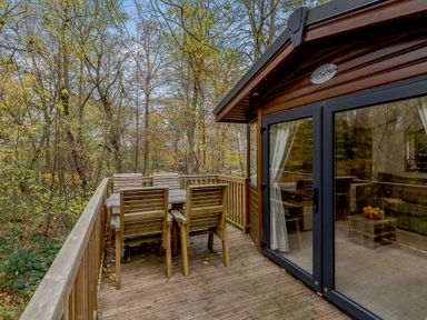 An outdoor deck with chairs and a table at Alford Spa in Louth