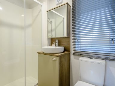 A bathroom with a shower and wash basin at Horncastle Spa in Louth