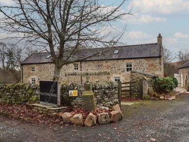 A sign and parking area at Falstone Barns in Hexham