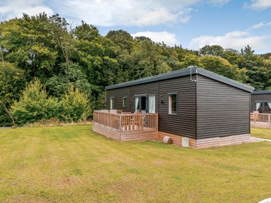 A cabin with a deck and windows at The Kinder Spa (Pet) Louth