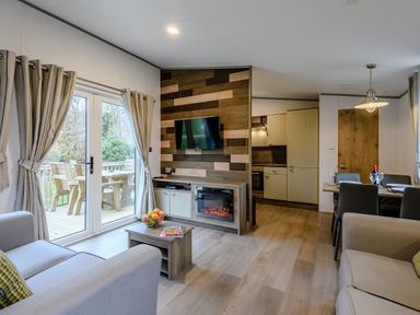 A living room with a sofa and television at The Kinder Spa (Pet) Louth