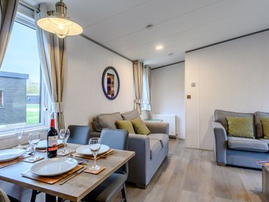 A living room with a dining table and seating area at The Kinder Spa (Pet) Louth