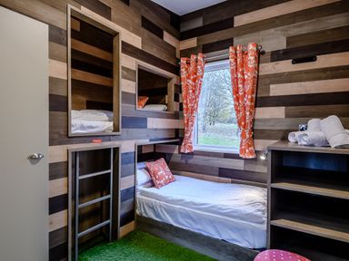 A bedroom with a bunk bed and shelves at The Kinder Spa (Pet) Louth
