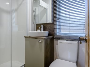 A bathroom with a shower, sink and toilet at The Kinder Spa (Pet) Louth
