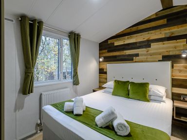A bedroom with a bed and window at Alford Spa (Pet) in Louth
