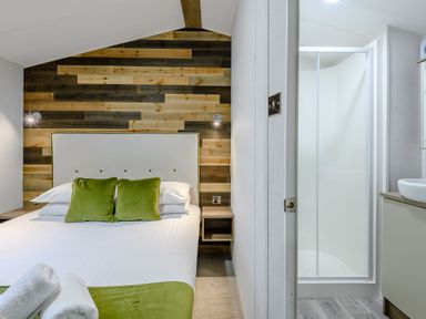 A bedroom with a bed and attached bathroom at Alford Spa (Pet) Louth
