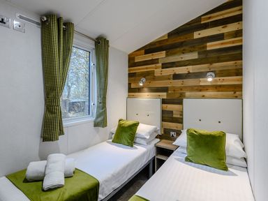 A bedroom with two beds and window at Alford Spa (Pet) in Louth