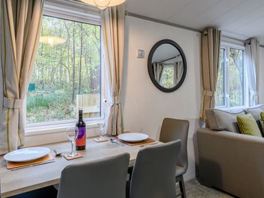A dining area with a table and chairs at Alford Spa (Pet) Louth