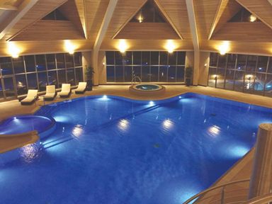 An indoor pool area with sun loungers and a jacuzzi at Alford Spa (Pet) Louth