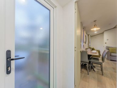 A dining room with a table and chairs visible through a door at Horncastle Spa Plus (Pet) in Louth