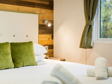 A bedroom with a bed and pillows at Horncastle Spa Plus (Pet) in Louth