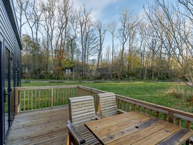 A deck with chairs and a table overlooking a grassy area at Horncastle Plus (Pet) in Louth