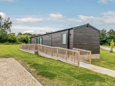 A cabin with a ramp and green grass at Alford WF in Louth