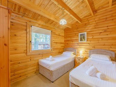 A bedroom with two beds and a window at Cedar Lodge in Louth