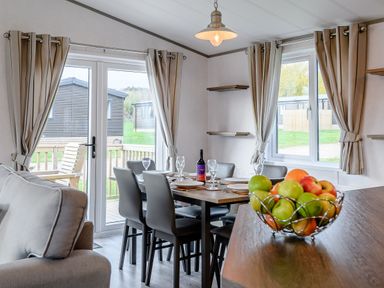 A dining room with a table and chairs at Elsham Lodge in Louth