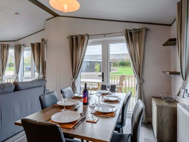 A dining room with a table set for meals at Elsham Lodge in Louth