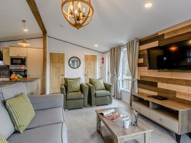 A living room with a sofa and chairs at Elsham Lodge in Louth