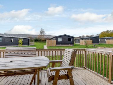 An outdoor seating area with a table and chairs at Elsham Lodge in Louth