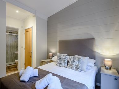 A bedroom with a bed and an adjoining bathroom at Stamford Spa in Louth