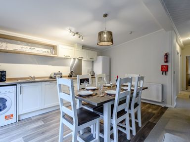 A kitchen with dining table and appliances at Stamford Spa in Louth