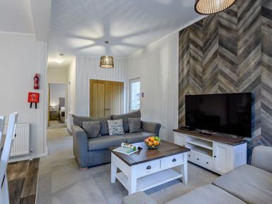 A living room with a sofa and television at Stamford Spa in Louth