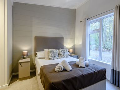 A bedroom with a bed and bedside table at Stamford Spa (Pet) in Louth