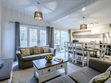 A living room with a sofa and dining table at Stamford Spa (Pet) Louth