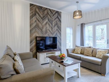 A living room with sofas and a television at Stamford Spa (Pet) Louth