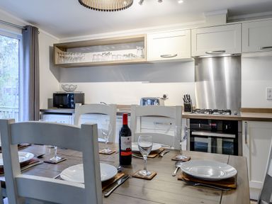 A kitchen with a dining table set at Stamford Spa (Pet) Louth