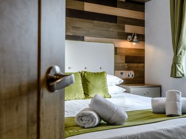 A bedroom with a bed and towels at Elsham Lodge (Pet) Louth