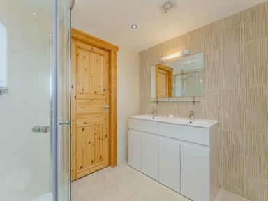A bathroom featuring a shower and a vanity unit at Hazel Lodge in Louth