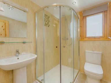 A bathroom with a shower, toilet, and sink at Hazel Lodge in Louth