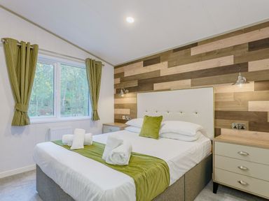 A bedroom with a bed and window at Brayford Lodge in Louth