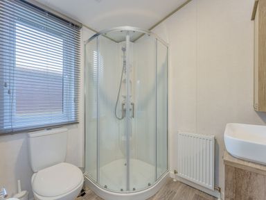 A bathroom with a shower, toilet, and sink at Brayford Lodge in Louth