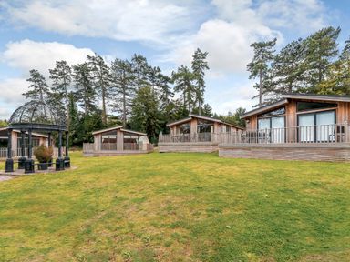 Several wooden lodges and a gazebo on grass at Retreat Lodge 4 in Louth