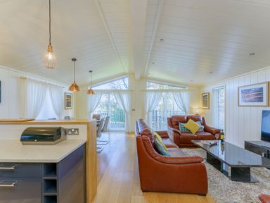 A living room with a sofa and dining area at Retreat Lodge 4 in Louth