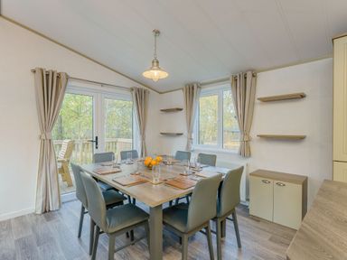A dining room with a table and chairs at Brayford Lodge Spa in Louth