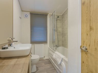 A bathroom with a shower and bathtub at Brayford Lodge Spa Louth