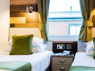 A bedroom with two beds and a window at Brayford Lodge Spa (Pet) in Louth
