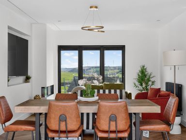 A dining room with a table and chairs at Heddfan in Carmarthen