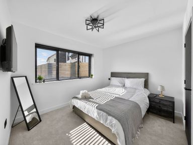 A bedroom with a bed and nightstand at Heddfan in Carmarthen