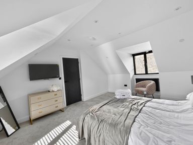 A bedroom with a bed and a television at Heddfan in Carmarthen