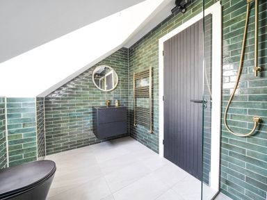 A bathroom with a shower and mirror at Heddfan in Carmarthen