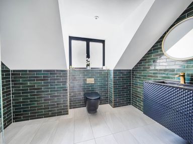 A bathroom with a toilet and sink at Heddfan in Carmarthen