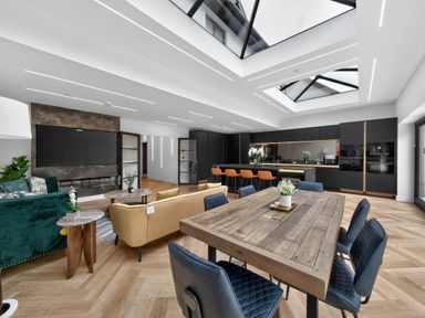 A kitchen with a dining area and living space at Ty Uchel